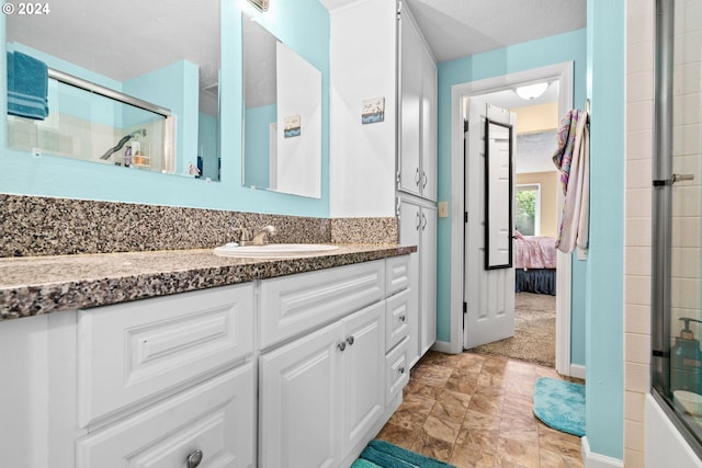 bathroom with a textured ceiling and vanity