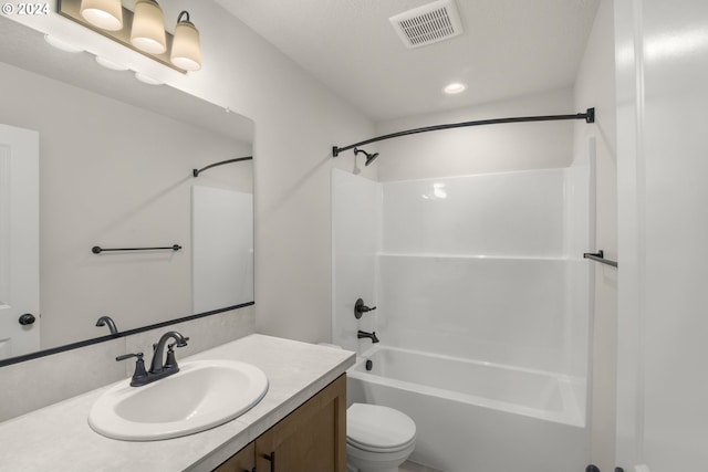 full bath with visible vents, shower / bathing tub combination, vanity, and toilet