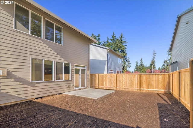 view of yard featuring a patio area and a fenced backyard