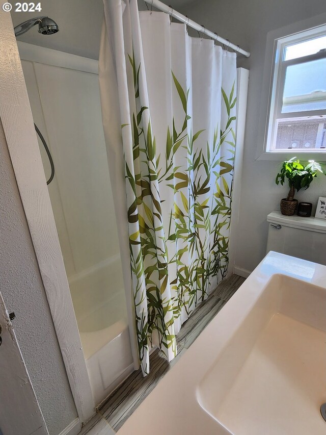 29840 Mary St, Gold Beach, OR 97444 - full bathroom with wood finished floors, toilet, and shower / bath combo