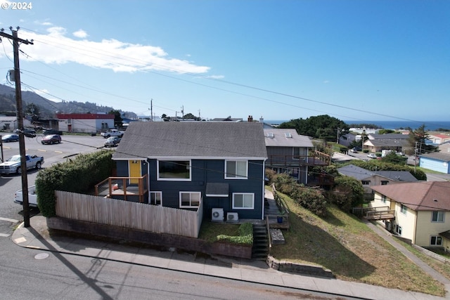 29840 Mary St, Gold Beach, OR 97444 - view of front of home with stairway, a shingled roof, a residential view, and fence