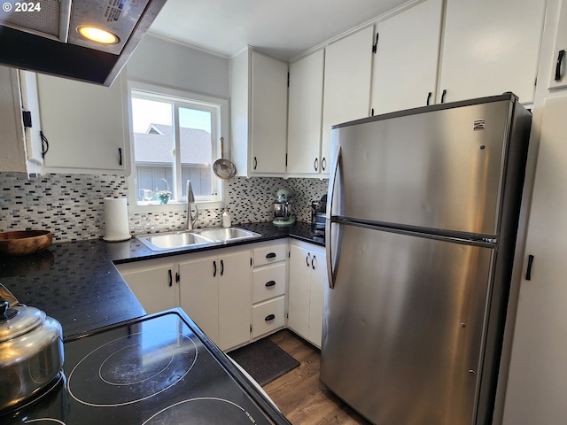 29840 Mary St, Gold Beach, OR 97444 - kitchen with dark countertops, decorative backsplash, freestanding refrigerator, white cabinetry, and a sink