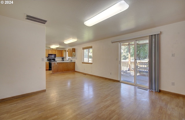 unfurnished living room featuring light wood-type flooring