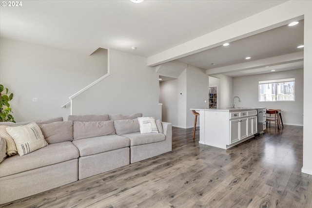 living room featuring baseboards, beamed ceiling, recessed lighting, and light wood-style floors