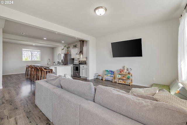 17347 NW Shackelford Rd, Portland, OR 97229 - kitchen with appliances with stainless steel finishes, wall chimney exhaust hood, a sink, a kitchen bar, and a center island with sink