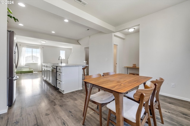 dining room featuring sink and hardwood / wood-style flooring