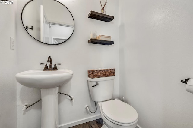 bathroom with toilet and hardwood / wood-style floors