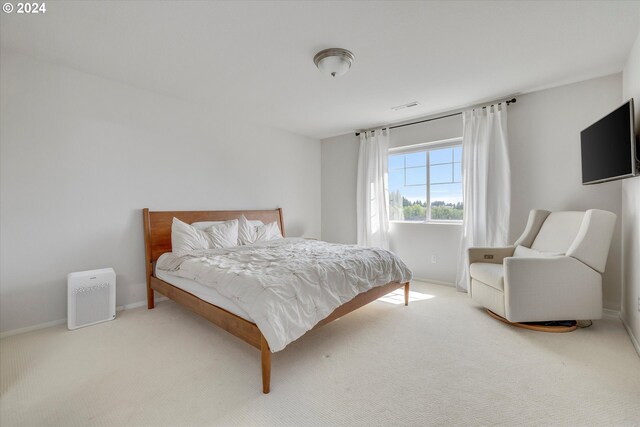 bedroom with light colored carpet