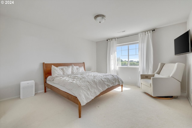 bedroom with light colored carpet, visible vents, and baseboards