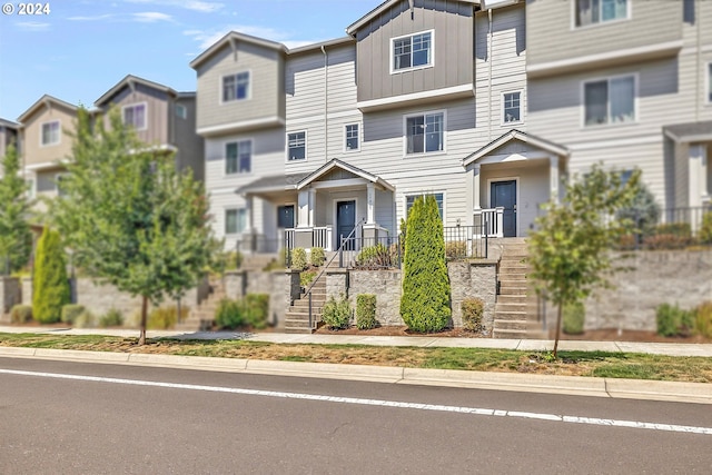 townhome / multi-family property with board and batten siding and stairs