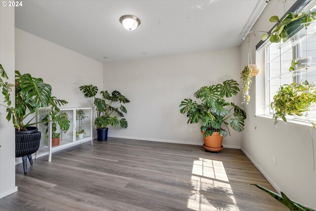 sitting room with wood finished floors and baseboards