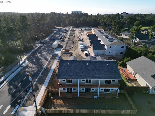 drone / aerial view with a wooded view