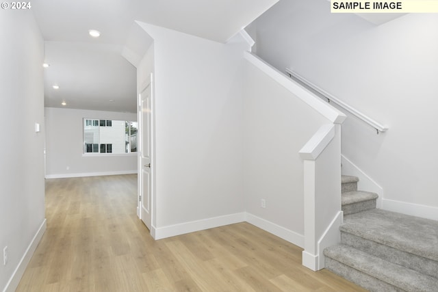 staircase featuring recessed lighting, baseboards, and wood finished floors