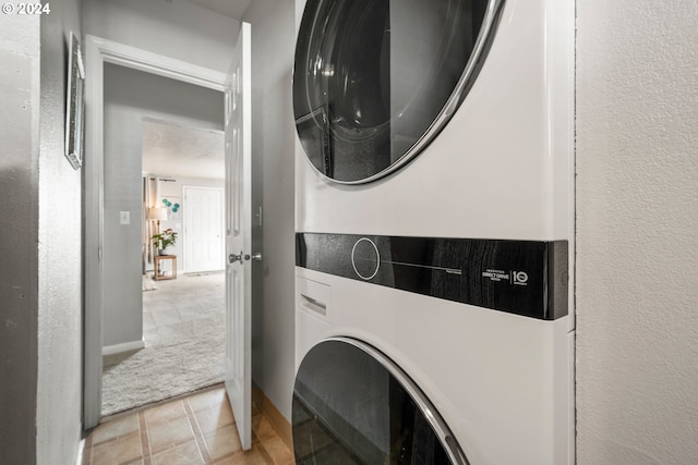 washroom with stacked washing maching and dryer and light colored carpet