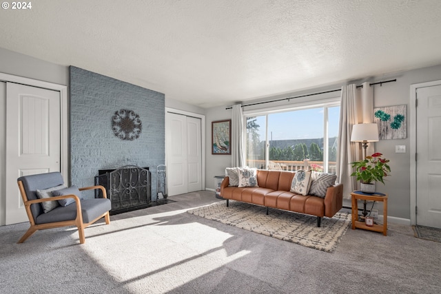 living room with a fireplace, a textured ceiling, and carpet