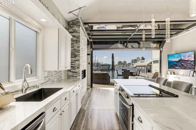 kitchen featuring sink, dark hardwood / wood-style flooring, white cabinetry, and stainless steel appliances