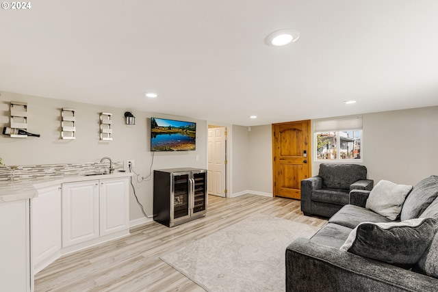 535 NE Bridgeton Rd Unit 7, Portland, OR 97211 - living room with light wood-type flooring, bar, baseboards, wine cooler, and recessed lighting