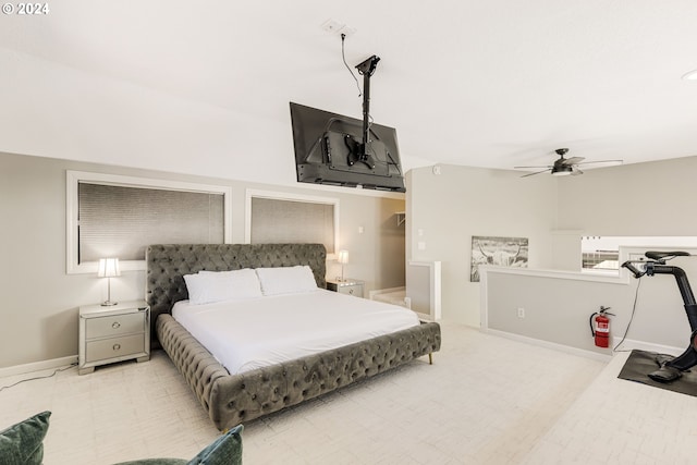 bedroom with ceiling fan and light carpet