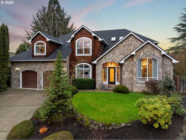 view of front of house featuring a yard and a garage