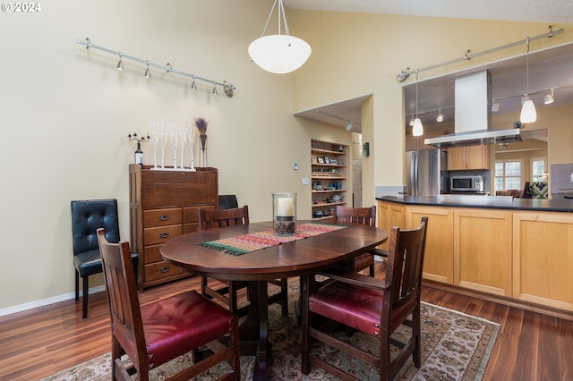 dining room featuring dark hardwood / wood-style floors and lofted ceiling