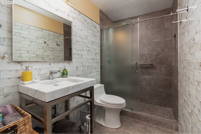 bathroom featuring tile patterned flooring, toilet, and a shower with shower door