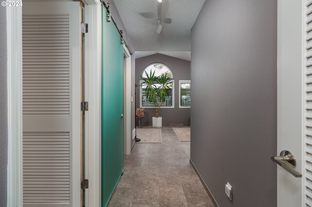 bedroom featuring a textured ceiling, vaulted ceiling, and multiple windows