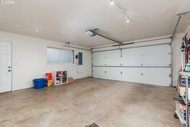 garage with electric panel and a garage door opener