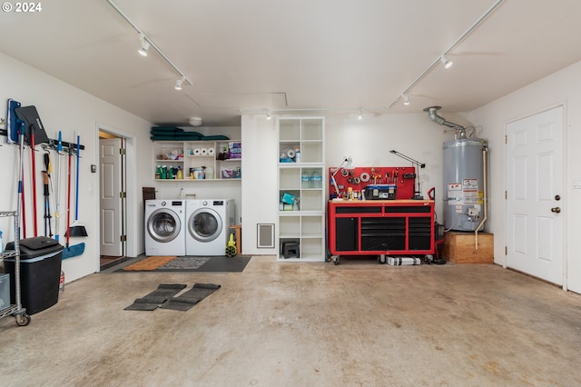 garage with washer and dryer, a workshop area, and water heater