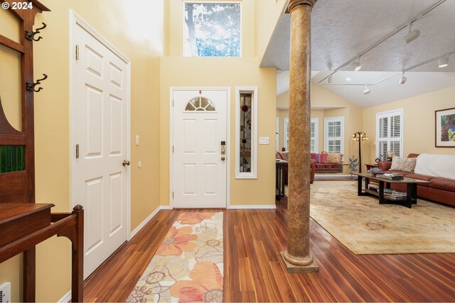 foyer featuring ornate columns and wood-type flooring