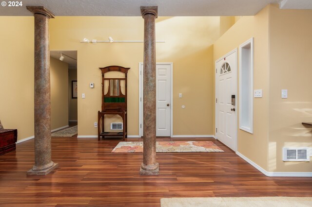 living room featuring a textured ceiling, track lighting, vaulted ceiling, and hardwood / wood-style flooring