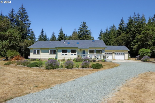 ranch-style home featuring a porch and a garage