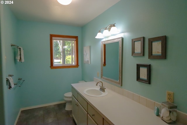 bathroom featuring vanity and toilet