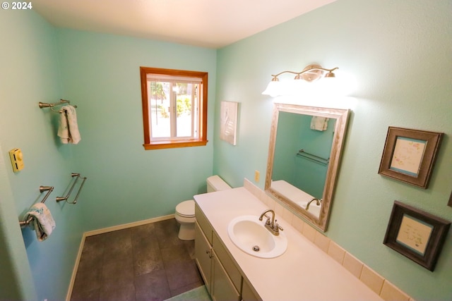 bathroom with vanity, toilet, and hardwood / wood-style floors