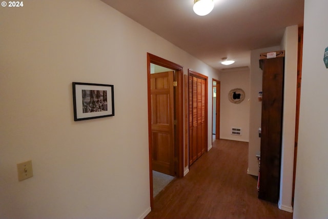 corridor with hardwood / wood-style flooring