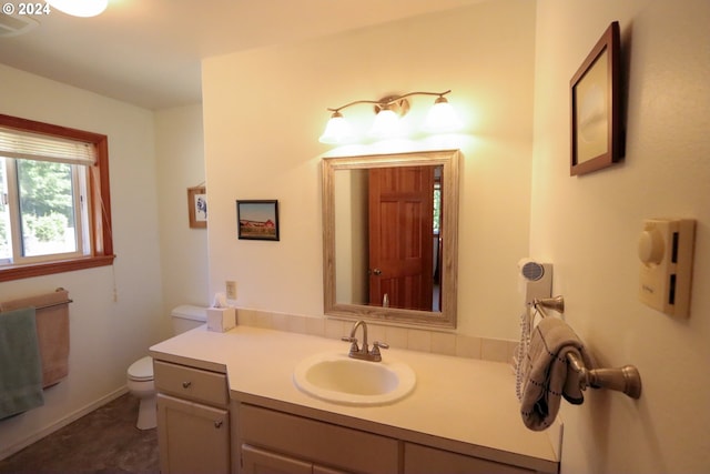 bathroom featuring vanity and toilet