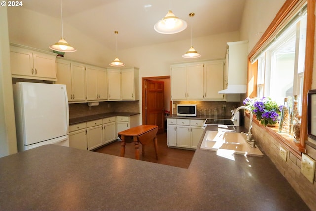 kitchen featuring tasteful backsplash, hanging light fixtures, white appliances, and sink