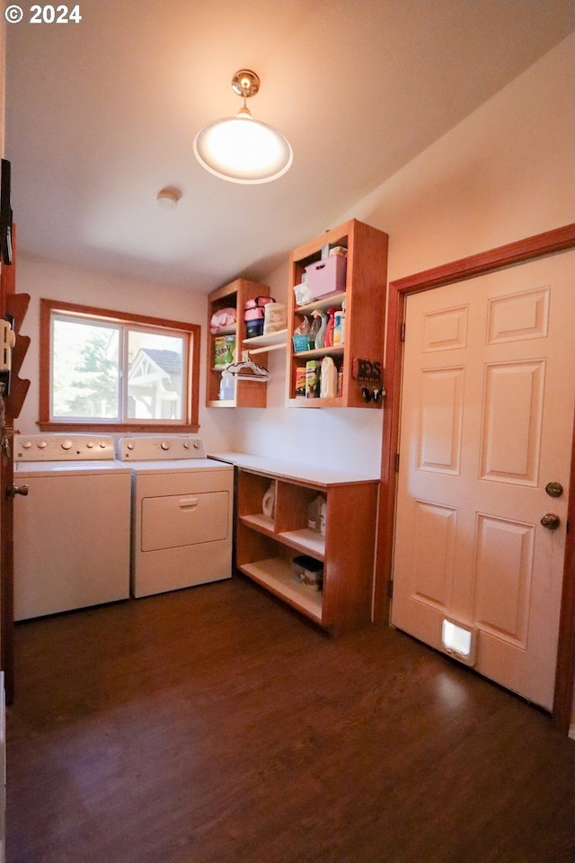 laundry room with dark wood-type flooring and washer and clothes dryer