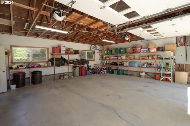 garage with a garage door opener and electric panel