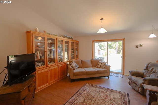 living room featuring lofted ceiling and light wood-type flooring