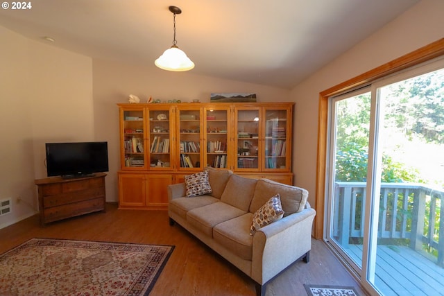 living room with lofted ceiling and hardwood / wood-style floors