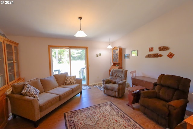 living room with wood-type flooring and vaulted ceiling