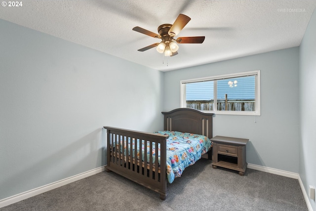 carpeted bedroom with ceiling fan and a textured ceiling