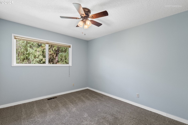 empty room with carpet flooring, ceiling fan, and a textured ceiling