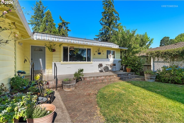 view of front facade with a patio and a front yard