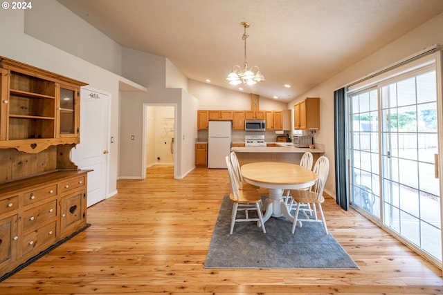 dining space with recessed lighting, baseboards, vaulted ceiling, light wood-type flooring, and an inviting chandelier