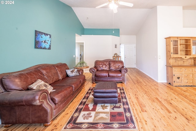 living room with baseboards, ceiling fan, high vaulted ceiling, and wood finished floors