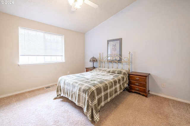 carpeted bedroom with lofted ceiling, visible vents, baseboards, and a ceiling fan