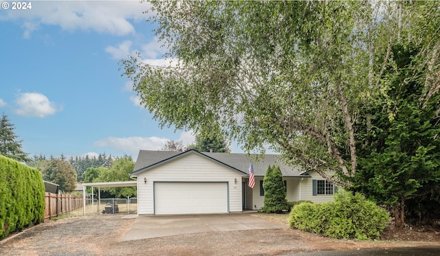 single story home with a garage, concrete driveway, a carport, and fence