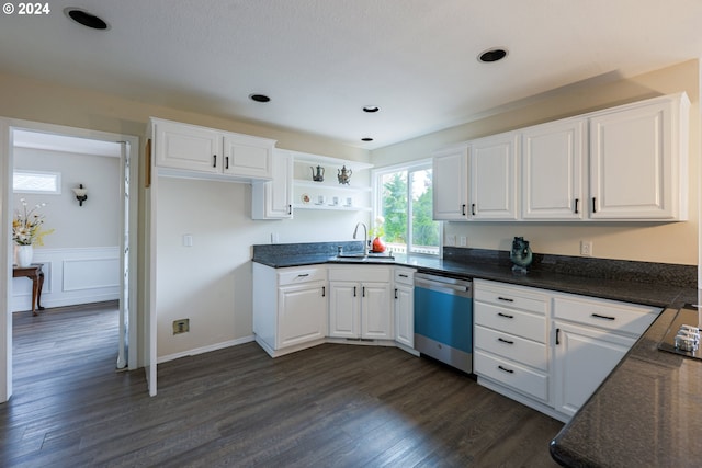 kitchen featuring sink, stainless steel dishwasher, dark hardwood / wood-style floors, and white cabinets