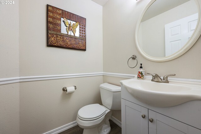 bathroom featuring toilet and vanity